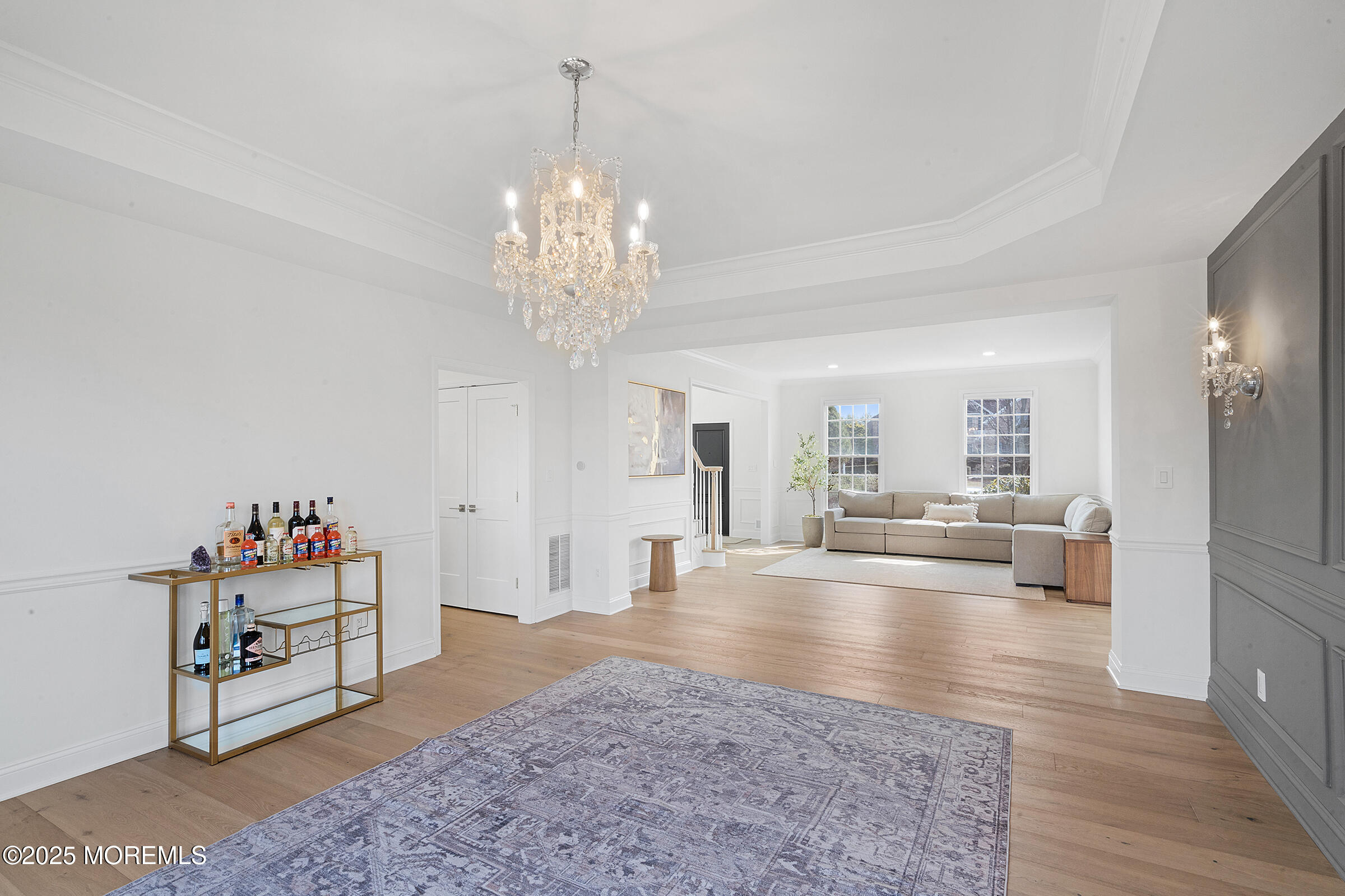 57 Moore Road Marlboro, NJ 07746 - Photo 20 of 53 a living room with furniture and a chandelier