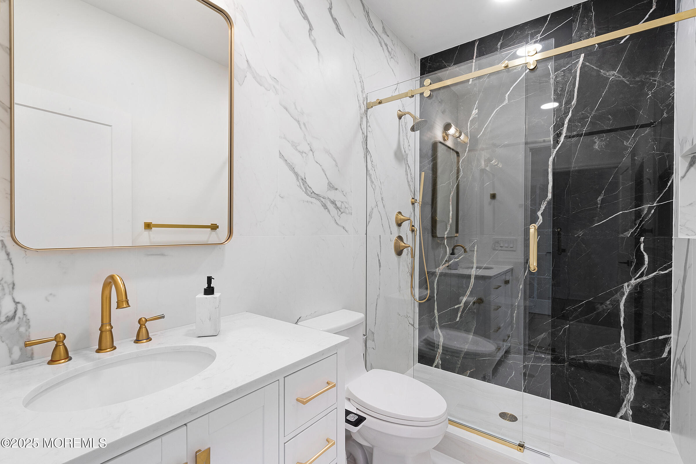 57 Moore Road Marlboro, NJ 07746 - Photo 24 of 53 a bathroom with a sink a toilet and shower