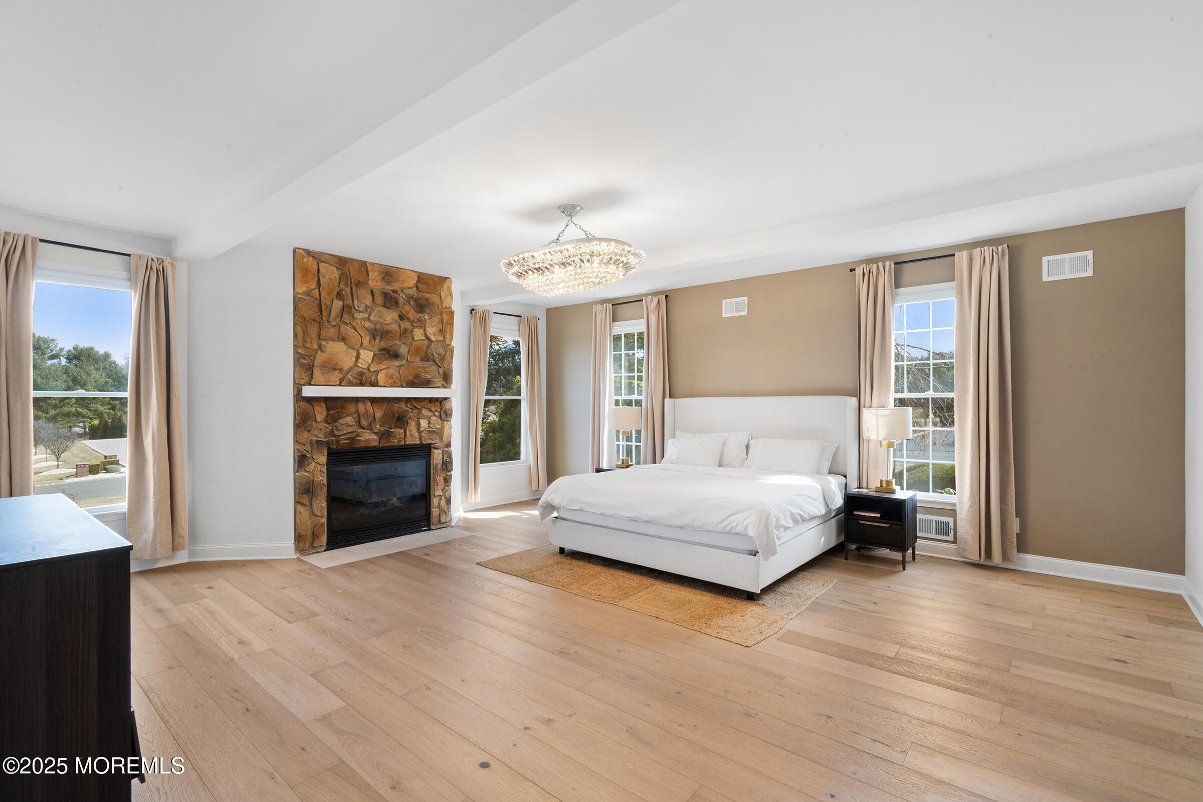 57 Moore Road Marlboro, NJ 07746 - Photo 26 of 53 a spacious bedroom with a large bed and a fireplace