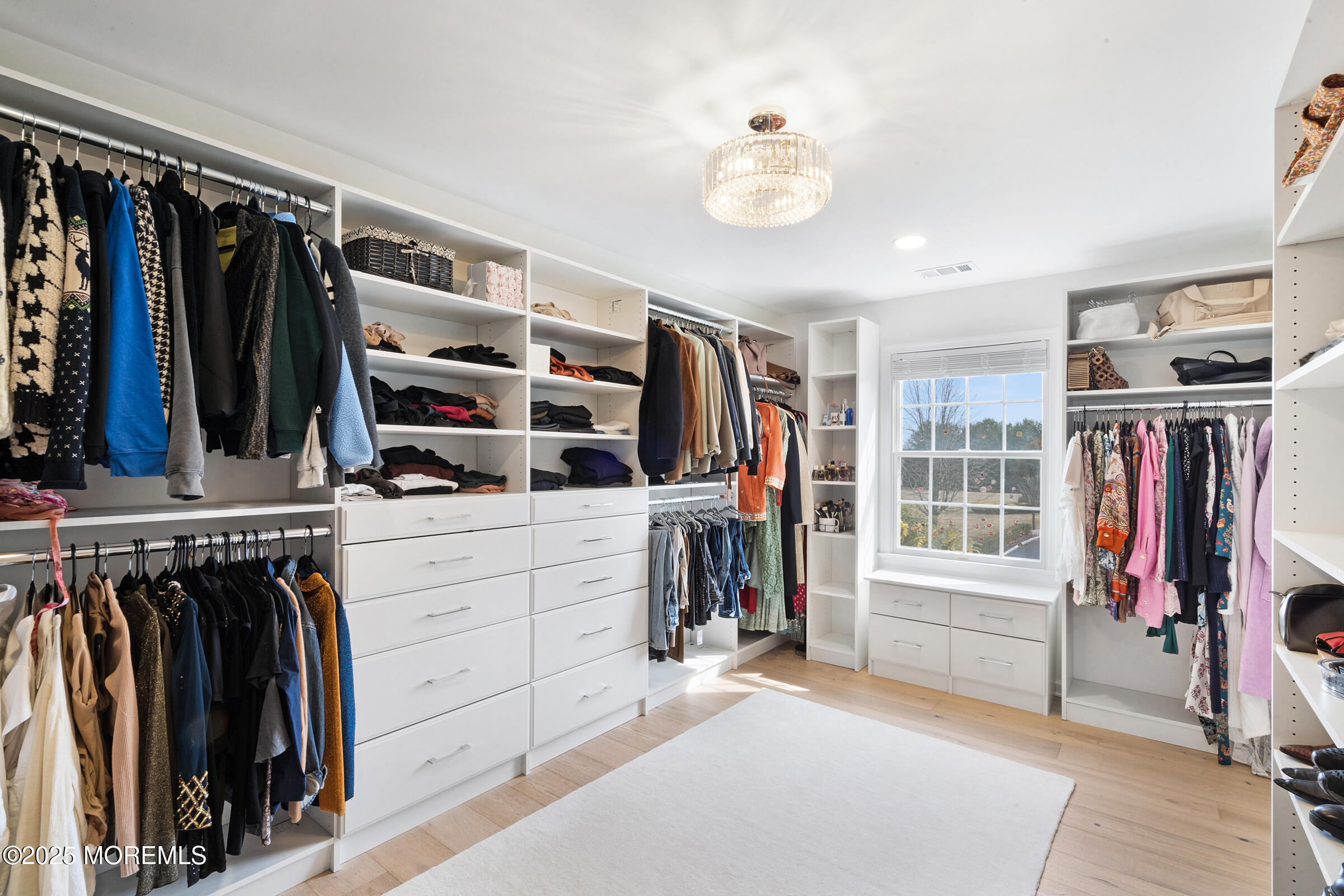 57 Moore Road Marlboro, NJ 07746 - Photo 30 of 53 a view of walk in closet with clothes and shoes