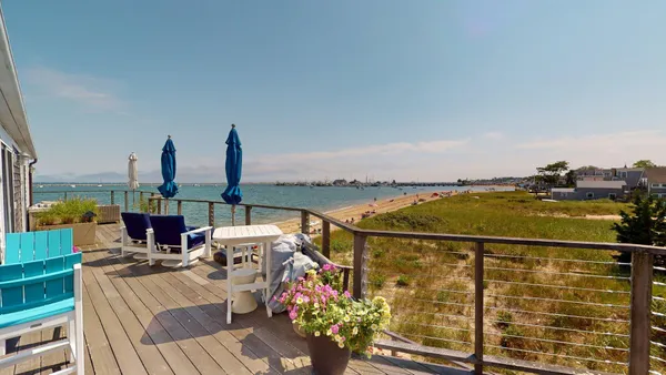 a view of a patio with table and chairs and potted plants