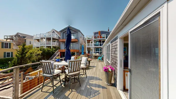 a view of a balcony with furniture and potted plants