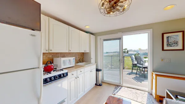 a kitchen with stainless steel appliances granite countertop a refrigerator a sink and a stove