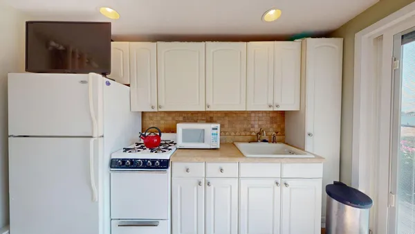 a white refrigerator freezer sitting inside of a kitchen