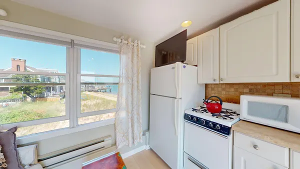 a kitchen with a refrigerator and a stove