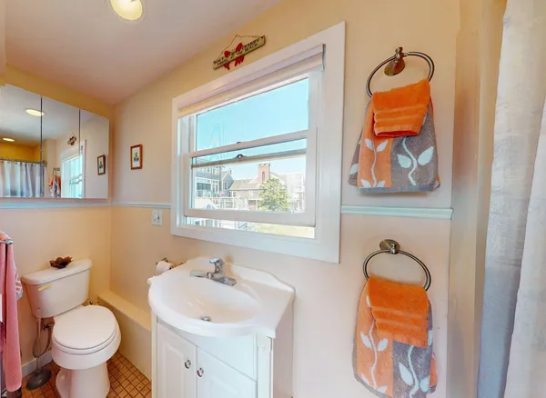 a bathroom with a bathtub and a window