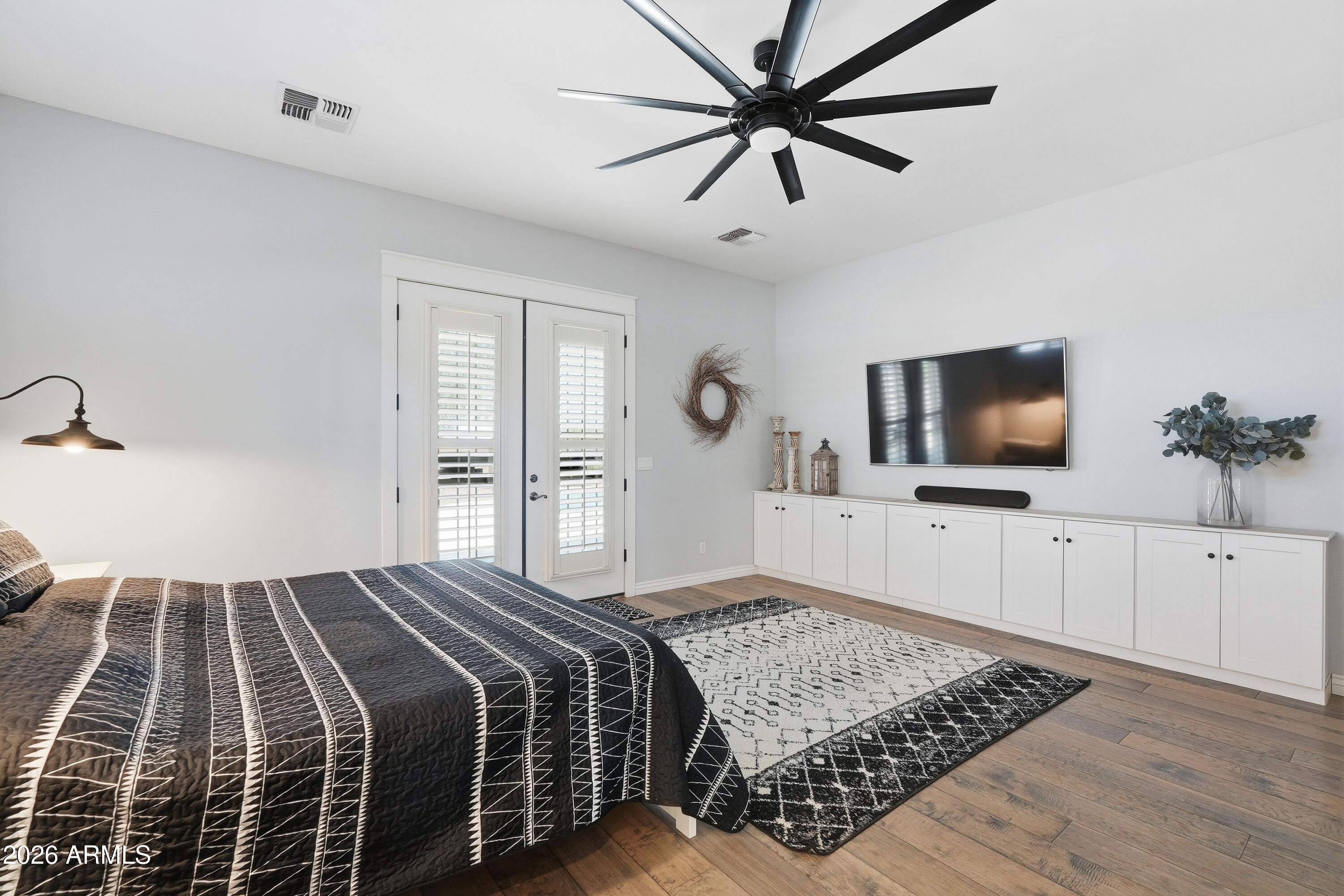 2616 West Canyon Road Phoenix, AZ 85086 - Photo 17 of 45 a bedroom with a bed and a flat screen tv