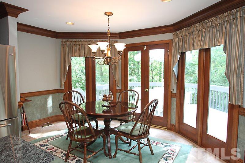 12332 Galway Drive Raleigh, NC 27613 - Photo 7 of 25 This spacious breakfast area features large full-length windows and double door access to the deck and backyard
