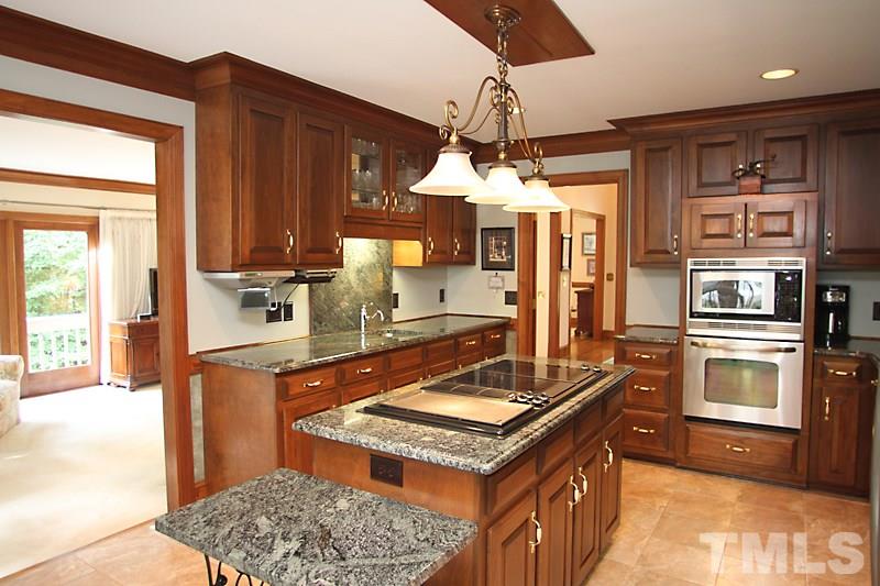 12332 Galway Drive Raleigh, NC 27613 - Photo 9 of 25 Another shot of the kitchen showing the wet bar / vegetable sink area and additional storage.