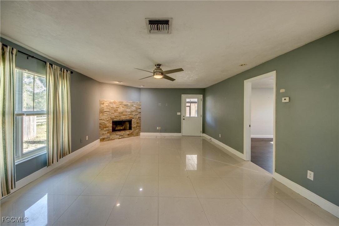 19330 Meredith Road North Fort Myers, FL 33917 - Photo 19 of 50 a view of an empty room with a window and fireplace