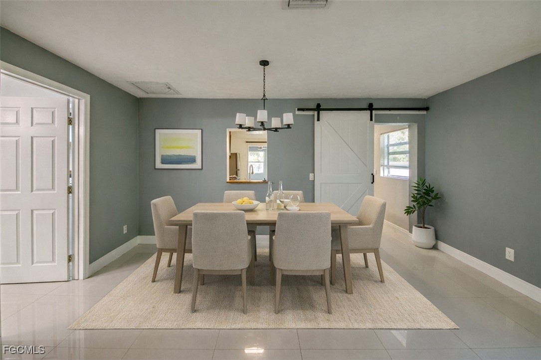 19330 Meredith Road North Fort Myers, FL 33917 - Photo 23 of 50 a dining room with furniture window and wooden floor