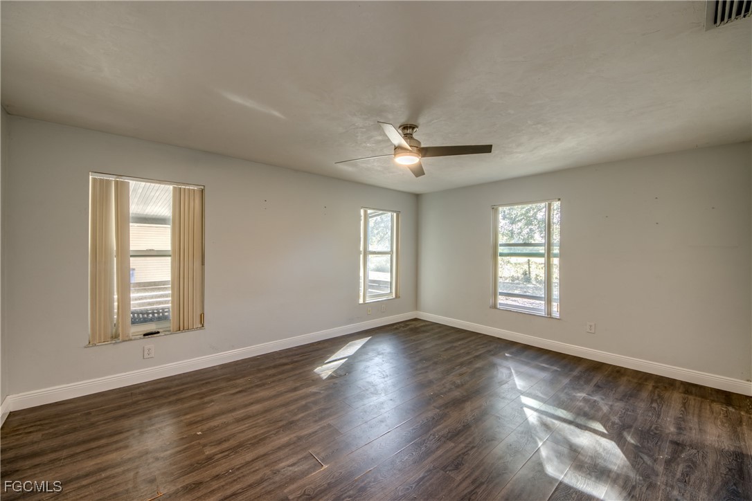 19330 Meredith Road North Fort Myers, FL 33917 - Photo 24 of 50 a view of an empty room with a window and wooden floor
