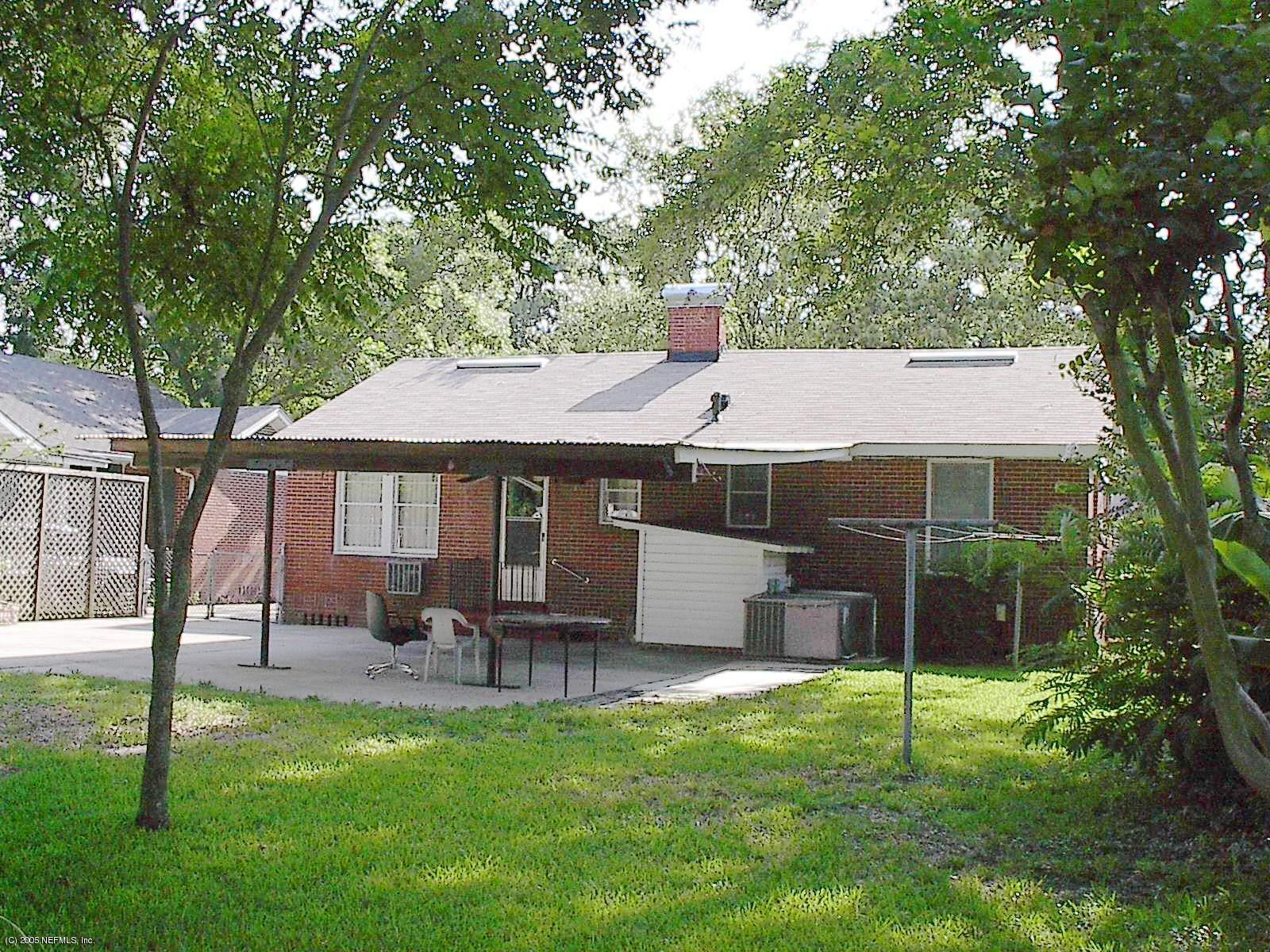 861 Old Hickory Road Jacksonville, FL 32207 - Photo 2 of 6 a front view of a house with a yard table and chairs