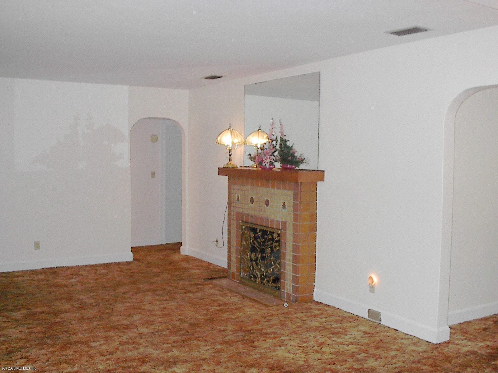 861 Old Hickory Road Jacksonville, FL 32207 - Photo 3 of 6 a view of an empty room with furniture and chandelier fan