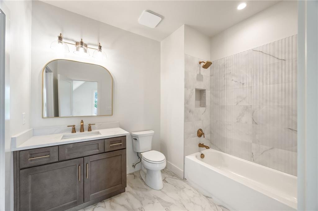2701 Conns Creek Road, Unit 53 Ball Ground, GA 30107 - Photo 11 of 19 a bathroom with a double vanity sink mirror double and bathtub