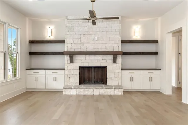a view of hallway with chandelier and wooden floor