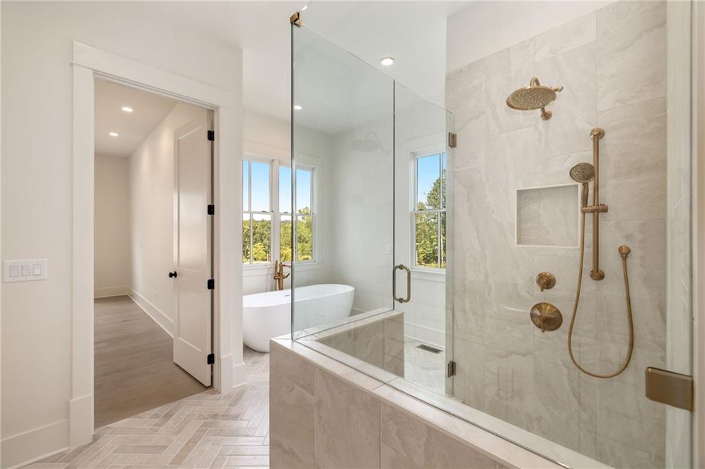 2701 Conns Creek Road, Unit 53 Ball Ground, GA 30107 - Photo 14 of 19 a bathroom with a glass shower door and a shower