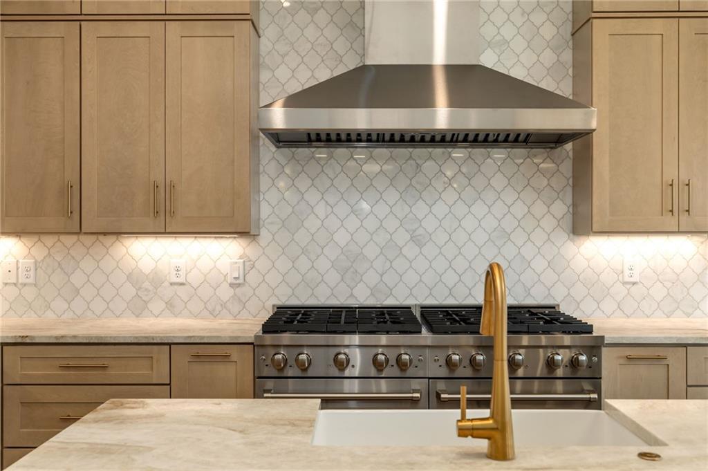 2701 Conns Creek Road, Unit 53 Ball Ground, GA 30107 - Photo 5 of 19 a kitchen with granite countertop a sink and a stove