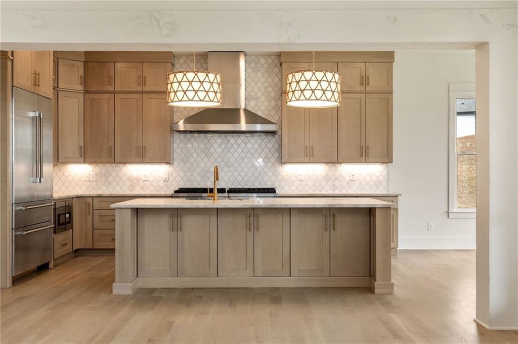 2701 Conns Creek Road, Unit 53 Ball Ground, GA 30107 - Photo 6 of 19 a kitchen with granite countertop a sink cabinets and stainless steel appliances