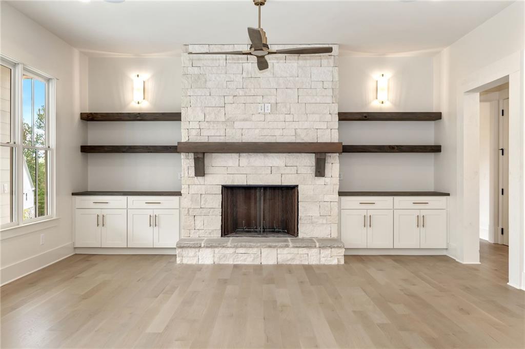 2701 Conns Creek Road, Unit 53 Ball Ground, GA 30107 - Photo 7 of 19 a kitchen with granite countertop a stove sink and cabinets