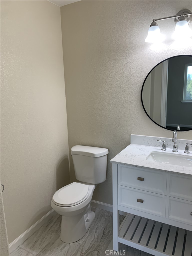 9781 Venturi Drive Cobb, CA 95426 - Photo 11 of 26 a bathroom with a toilet a sink and mirror