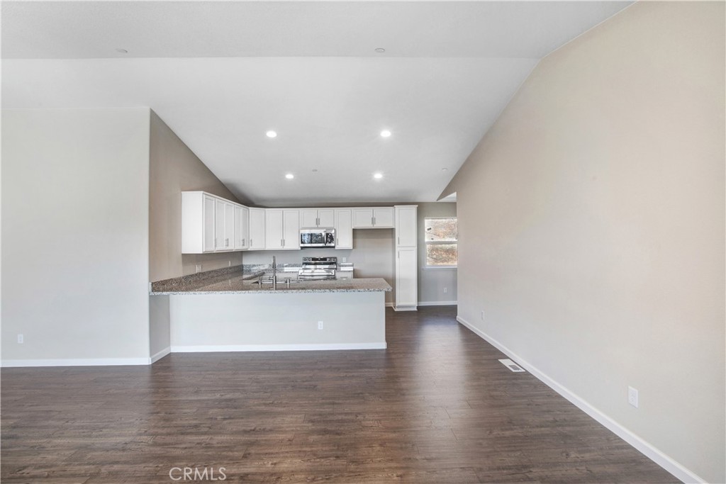 9781 Venturi Drive Cobb, CA 95426 - Photo 12 of 26 a view of kitchen with kitchen island a sink wooden floor and a refrigerator