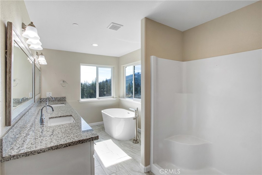 9781 Venturi Drive Cobb, CA 95426 - Photo 20 of 26 a spacious bathroom with a granite countertop sink and a large mirror