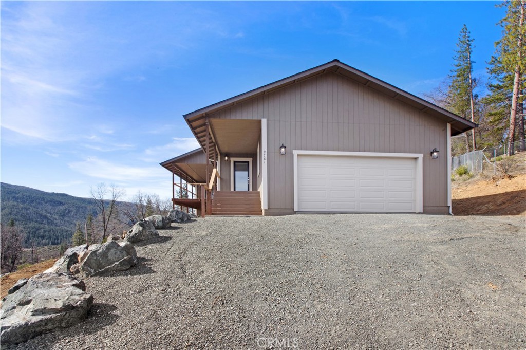 9781 Venturi Drive Cobb, CA 95426 - Photo 5 of 26 a front view of a house with a yard and garage