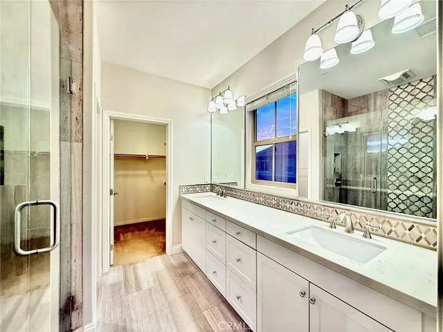 a spacious bathroom with a sink double vanity and a mirror