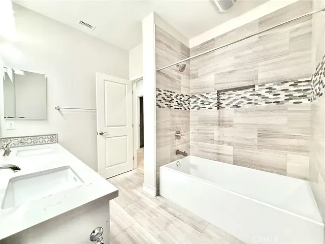 a bathroom with a tub a sink and a shower