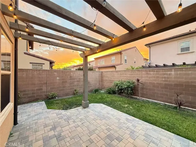 a view of a backyard with plants and a patio
