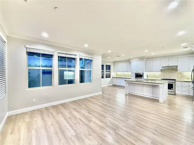 a view of kitchen with kitchen island wooden cabinets and stainless steel appliances