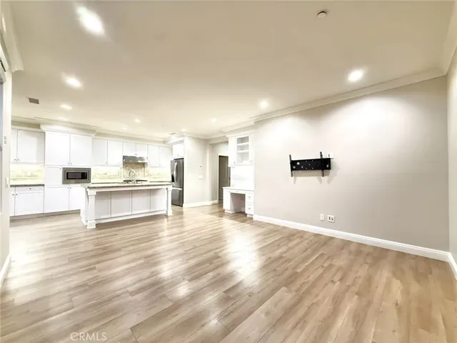 a view of kitchen with kitchen island and stainless steel appliances