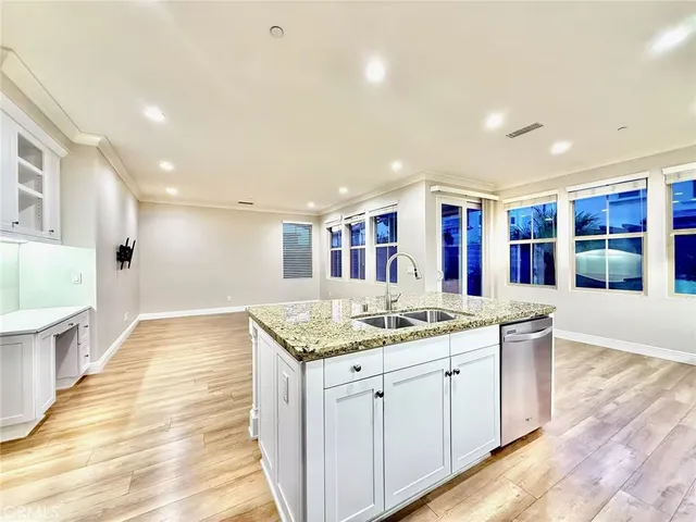 a spacious bathroom with a granite countertop sink and a large mirror