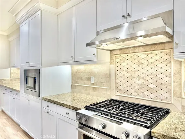 a stove top oven sitting inside of a kitchen