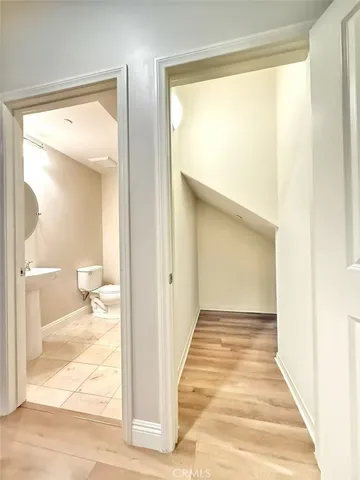 a view of a room with wooden floor and a floor to ceiling window