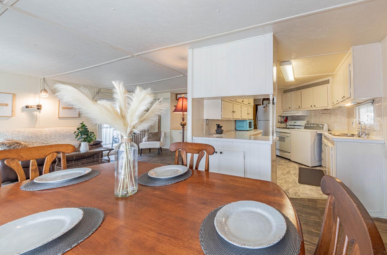 55 San Juan Grade Road, Unit 79 Salinas, CA 93906 - Photo 7 of 22 a kitchen with stainless steel appliances granite countertop a sink a stove a dining table and chairs