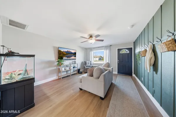 a living room with furniture and a chandelier