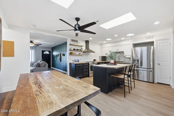 a kitchen with a table chairs sink and cabinets