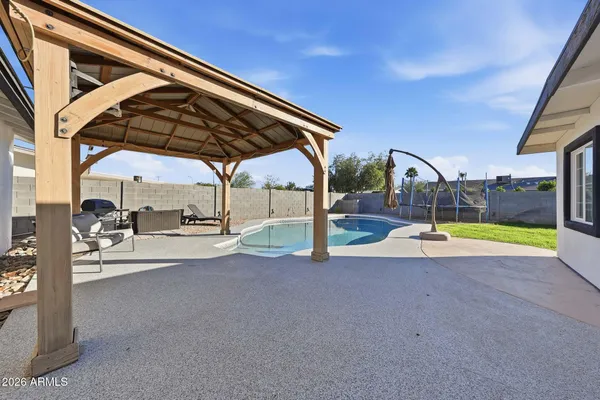a view of swimming pool with sitting area