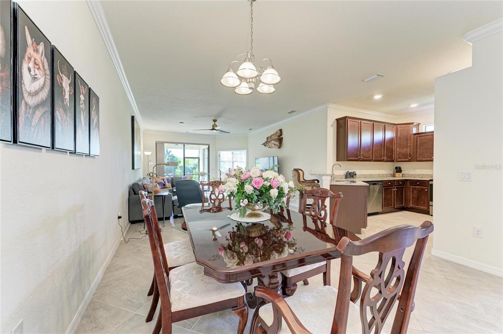 12440 Amica Loop Venice, FL 34293 - Photo 20 of 87 a view of a dining room with furniture and chandelier