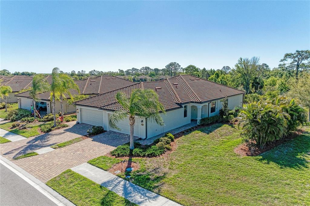 12440 Amica Loop Venice, FL 34293 - Photo 2 of 87 a front view of a house with a yard