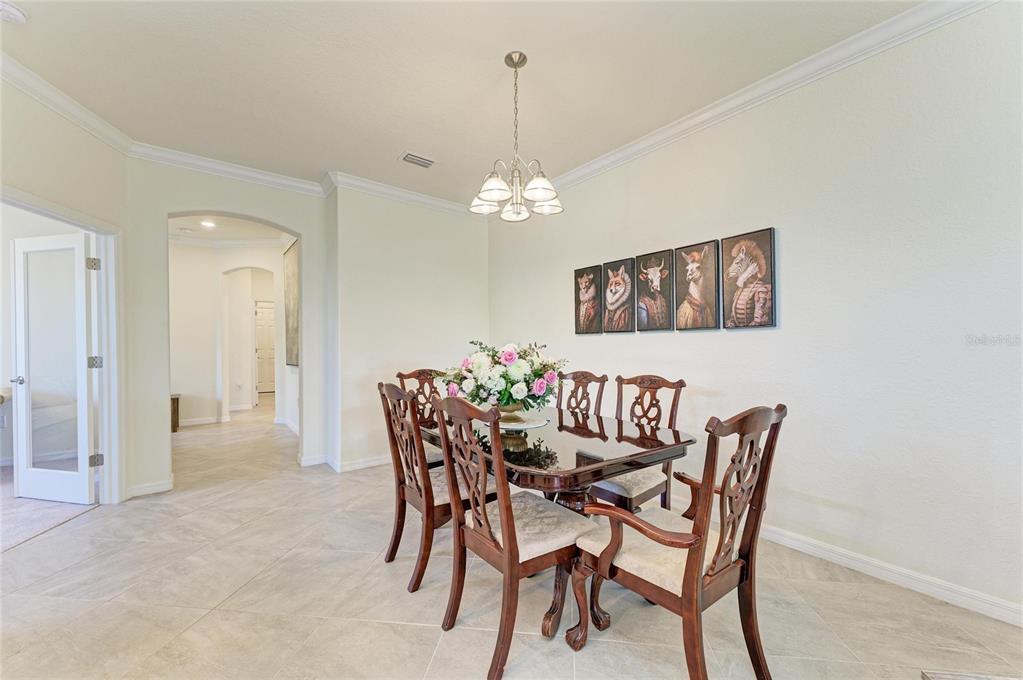 12440 Amica Loop Venice, FL 34293 - Photo 21 of 87 a view of a dining room with furniture