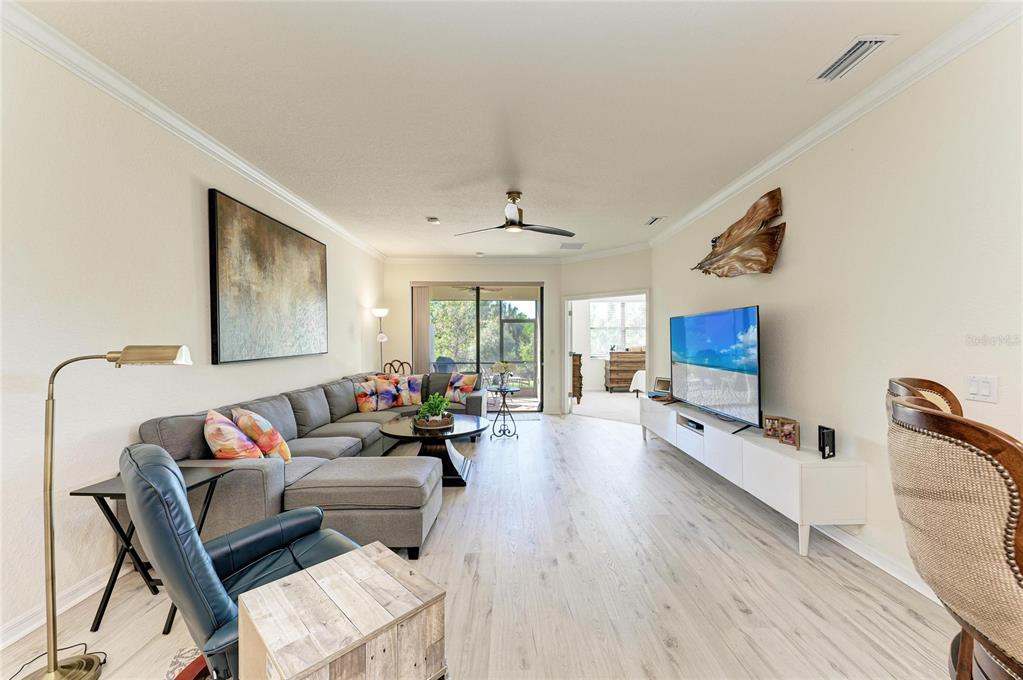 12440 Amica Loop Venice, FL 34293 - Photo 30 of 87 a living room with furniture and a flat screen tv