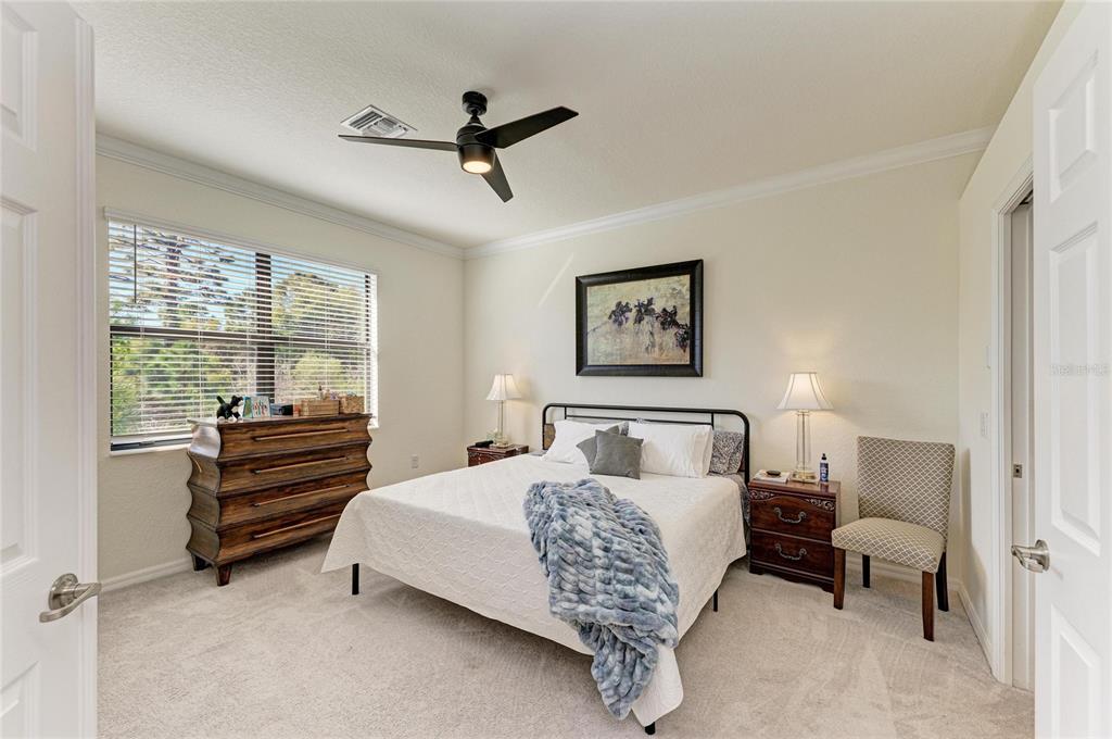 12440 Amica Loop Venice, FL 34293 - Photo 37 of 87 a bedroom with a bed and a chandelier