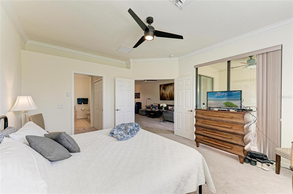 12440 Amica Loop Venice, FL 34293 - Photo 40 of 87 a bedroom with a bed and wooden floor