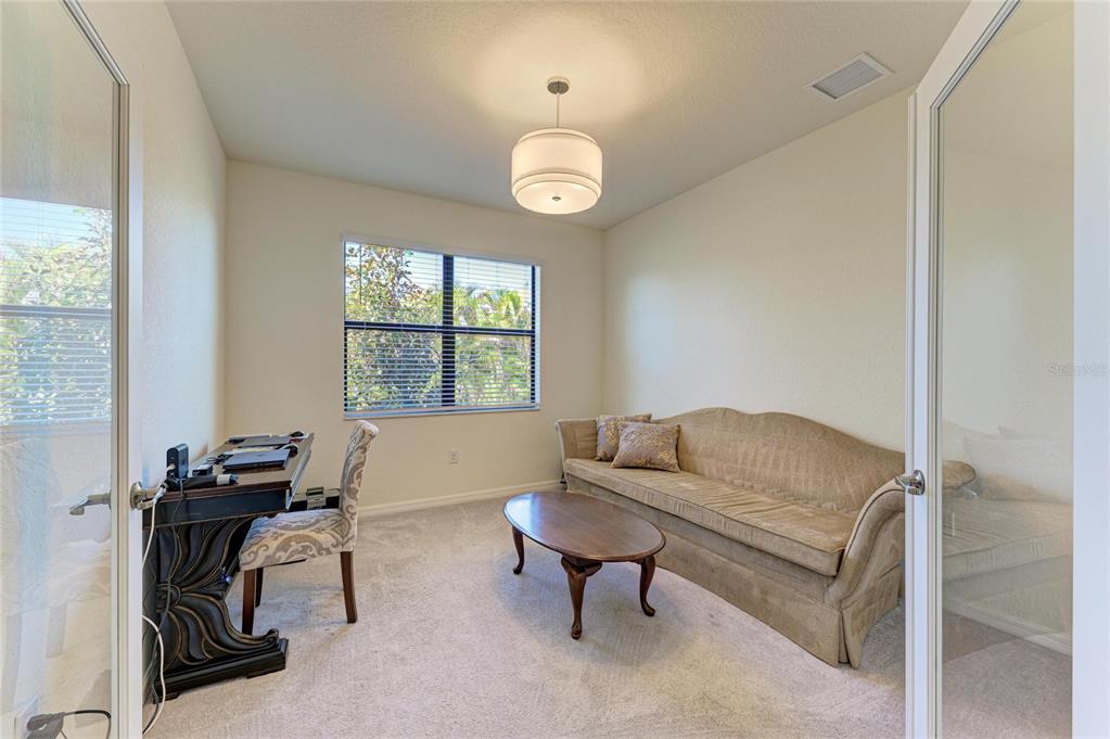 12440 Amica Loop Venice, FL 34293 - Photo 51 of 87 a living room with furniture a window and a table