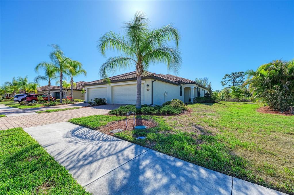 12440 Amica Loop Venice, FL 34293 - Photo 9 of 87 a front view of house with yard and green space