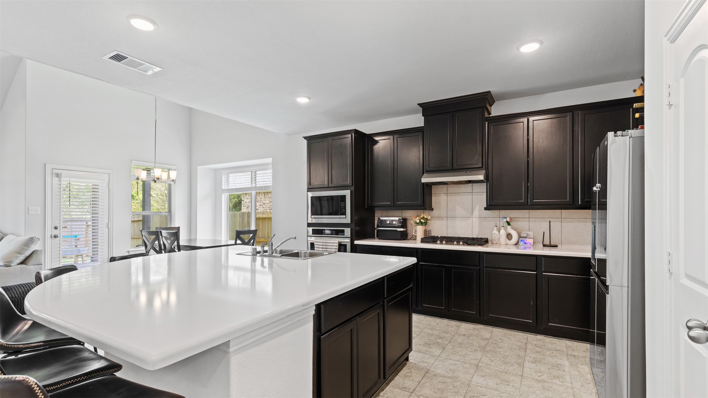 222 Butterfly Orchid Court Conroe, TX 77318 - Photo 1 of 33 a kitchen with counter top space sink and center