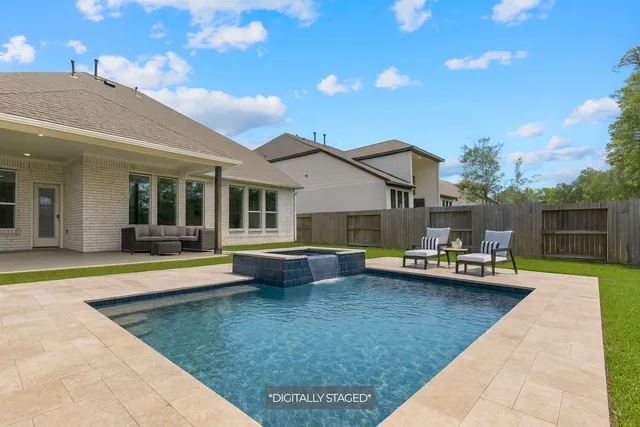 a view of a house with swimming pool and sitting area